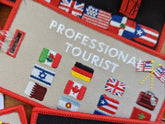 PROFESSIONAL TOURIST Luggage Tag. Worldwide! Taupe background