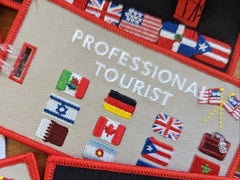 PROFESSIONAL TOURIST Luggage Tag. Worldwide! Taupe background